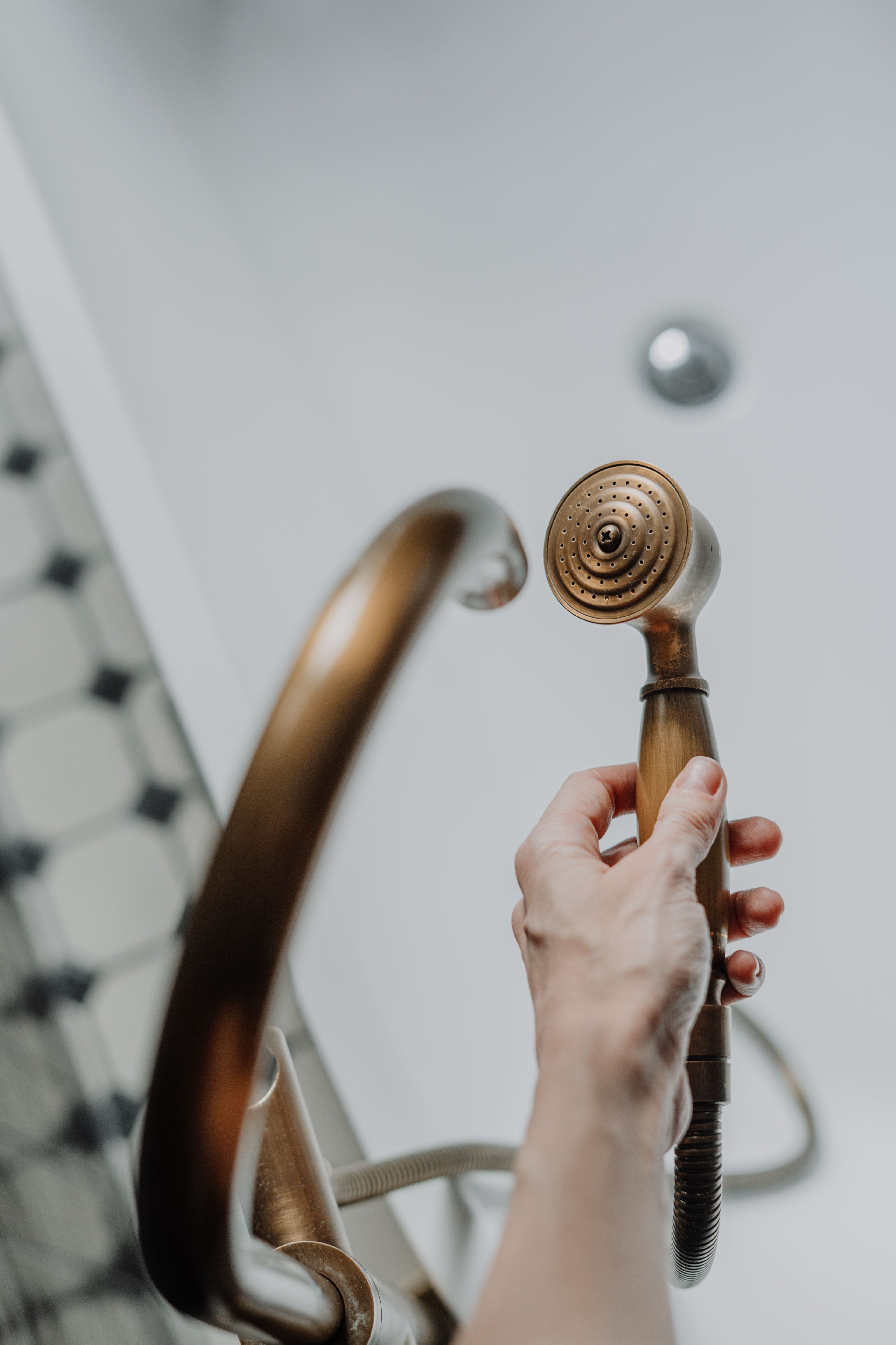Hand holding a handheld shower head