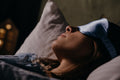 Person sleeping wearing a contoured eye mask