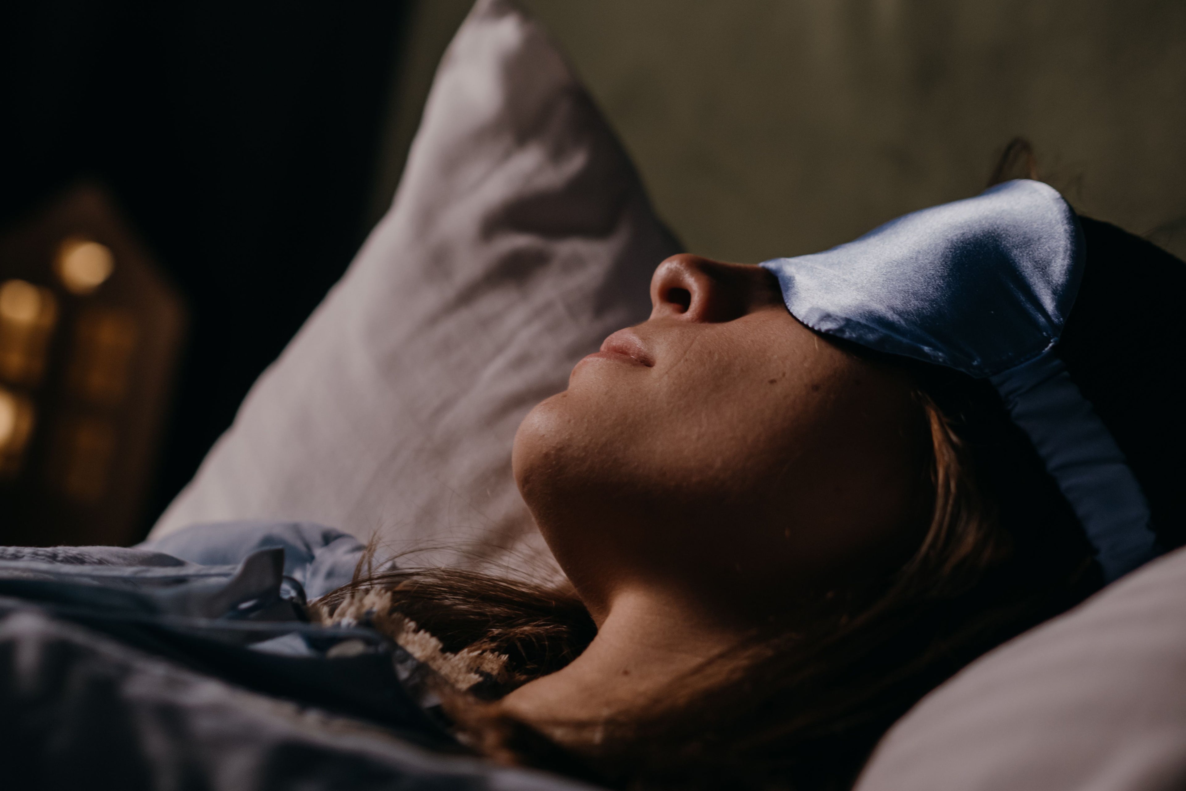 Person sleeping wearing a contoured eye mask